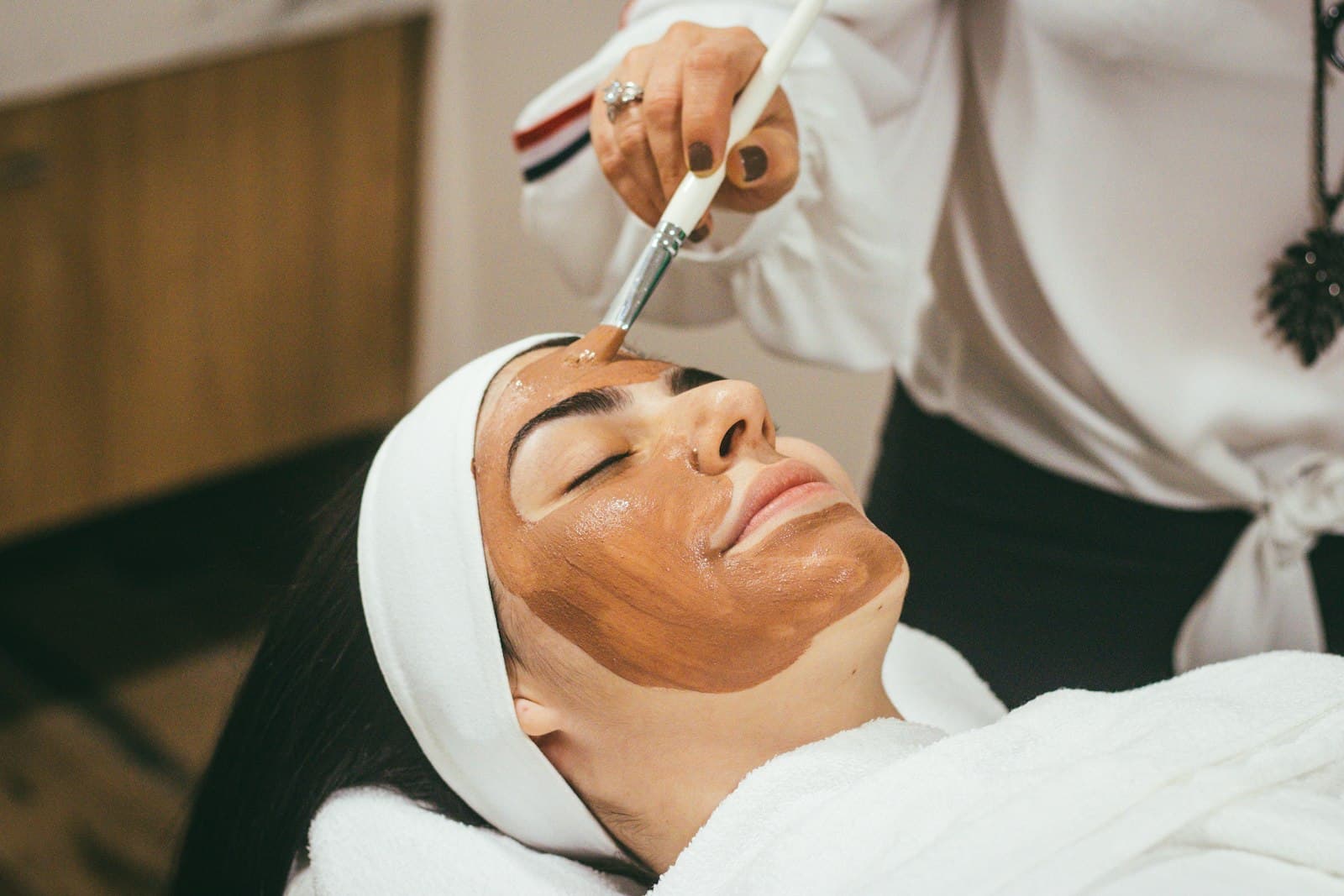 Client relaxing during a facial mask treatment