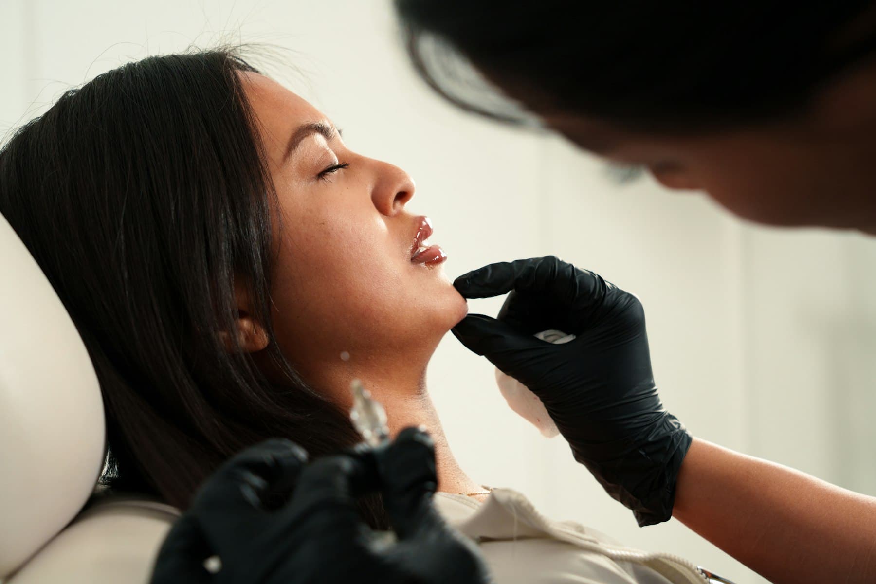 Injector performing a filler treatment on a client in a bright med spa